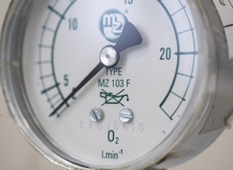 A close up of a pressure gauge on a pipe