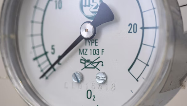 A close up of a pressure gauge on a pipe
